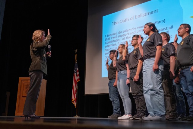 Gen. Laura J. Richardson, Commander, U.S. Southern Command, administers the Oath of Enlistment to sixteen new Army Recruits during a visit to Northglenn High School, Northglenn, Colorado, April 27, 2023. Richardson, a Northglenn alumni, visited the school to explain the benefits of military service to current students.