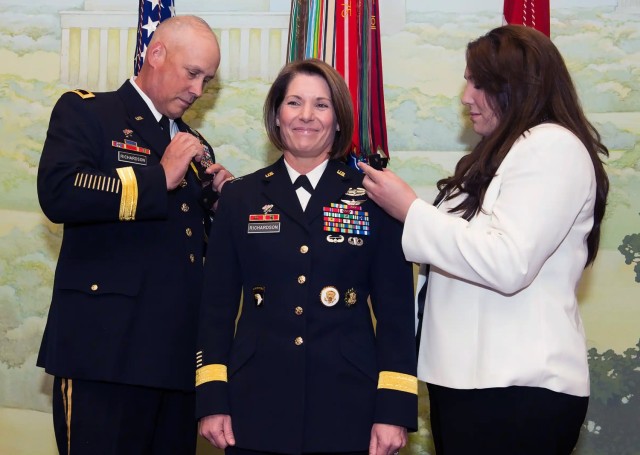  Maj. Gen. Laura Richardson’s husband, Maj. Gen. Jim Richardson and daughter Lauren pin on her new rank during her promotion ceremony at Joint Base Myer-Henderson Hall, Virginia, Aug. 14, 2014. 