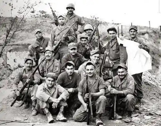 Members of the 65th Infantry Regiment pose for a photo after a firefight during the Korean War. The regiment consisted primarily of Puerto Rican soldiers who spoke mainly Spanish and prided themselves on having mustaches. By 1953, the regiment’s soldiers had earned 14 Silver Stars, 23 Bronze Stars for valor and 67 Purple Hearts.
